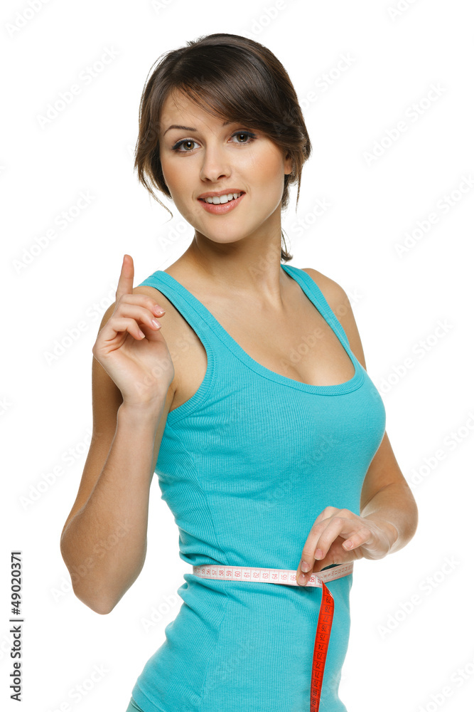 Woman measuring her waist with tape with finger up Woman measuring her waist with tape with finger up