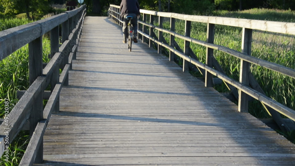senior old man with cap drive bicycle wooden long bridge lake senior old man with cap drive bicycle wooden long bridge lake