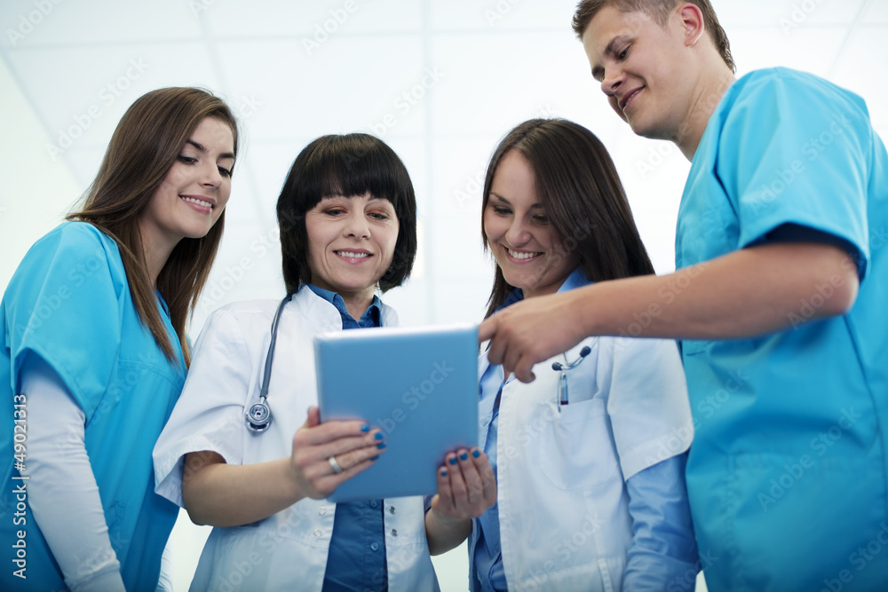 Medical team checking results on digital tablet Medical team checking results on digital tablet