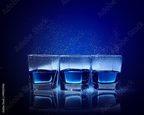 Three glasses of blue liquid