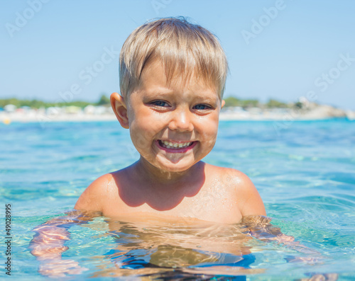 Young boy swimming in sea © Max Topchii