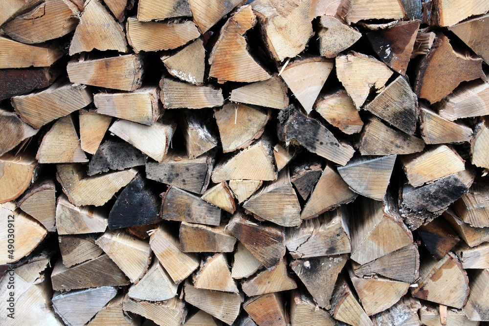 Neatly stacked split logs for firewood Neatly stacked split logs for firewood