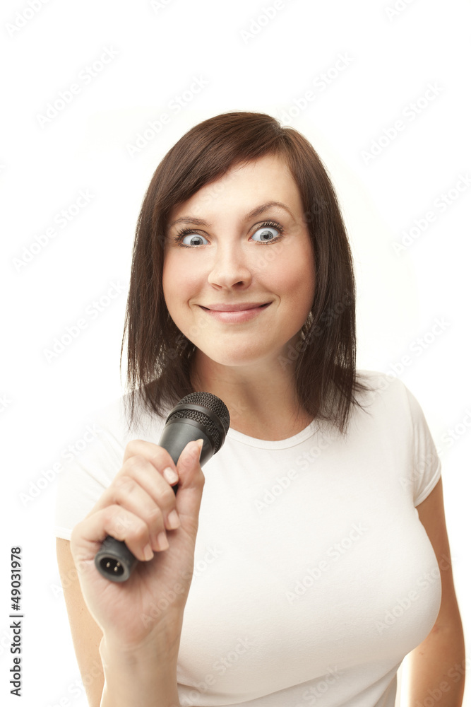 Young woman holding microphone and crazy smiling Young woman holding microphone and crazy smiling