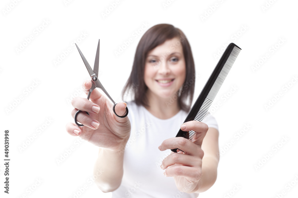 Young hairdresser holding scissors and comb isolated Young hairdresser holding scissors and comb isolated