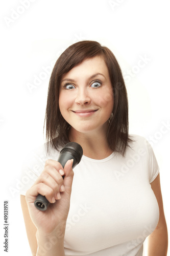 Young woman holding microphone and crazy smiling