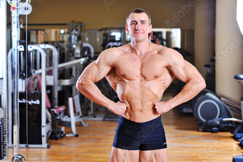 Bodybuilder posing in gym