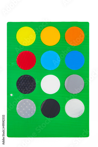 green sheet with different colorful round color samples © travelview