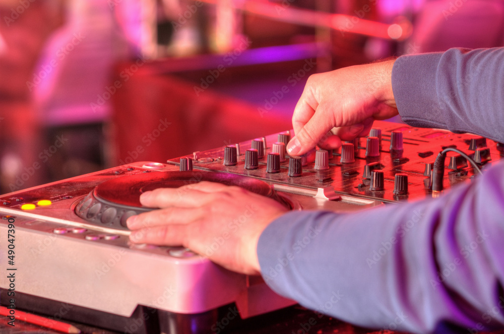 Dj mixes the track in the nightclub at a party Dj mixes the track in the nightclub at a party