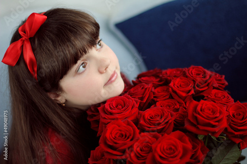 Portrait of attractive teen girl with red roses bouquet flowers photo