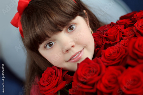 Portrait of attractive teen girl with red roses bouquet flowers photo