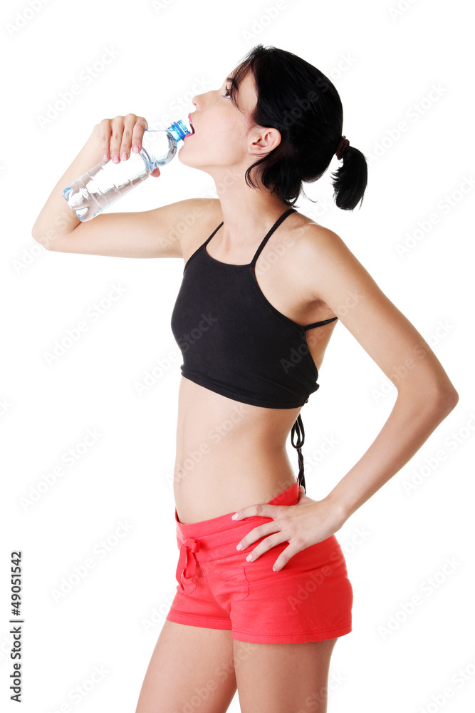 Young fit woman drinking mineral water Young fit woman drinking mineral water