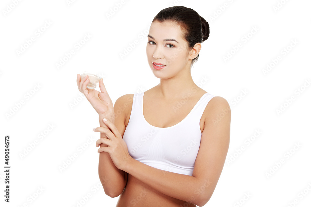 Woman in underwear with moisturizer cream. Woman in underwear with moisturizer cream.