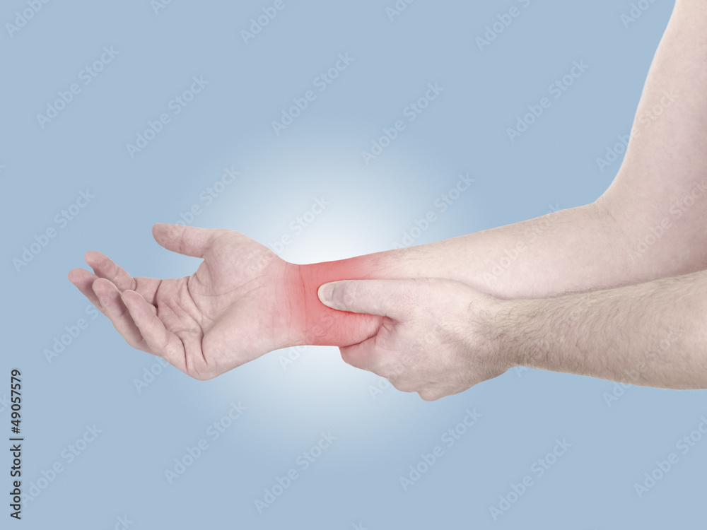 Acute pain in a man wrist. Male holding hand to spot of wrist pa