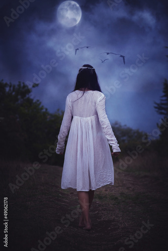 portrait of carefree young woman in white dress photo