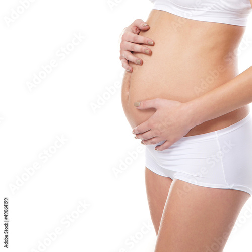 Body of a young pregnant woman on white