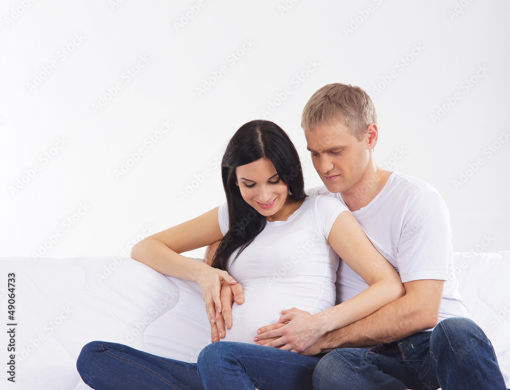 A young and lovely couple: happy man and pregnant woman A young and lovely couple: happy man and pregnant woman