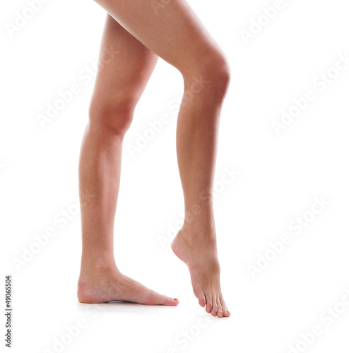 Legs of a beautiful woman isolated on white © Acronym