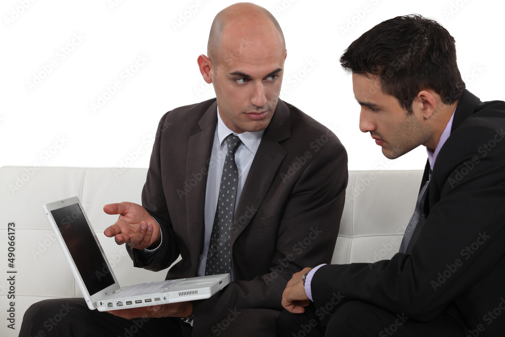Serious businessmen with a laptop Serious businessmen with a laptop