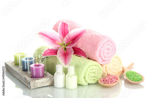Fototapeta Naklejka Na Ścianę i Meble -  towels with lily, aroma oil,  candles and sea salt isolated