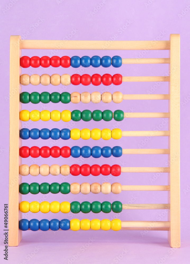 Bright wooden toy abacus, on purple background Bright wooden toy abacus, on purple background