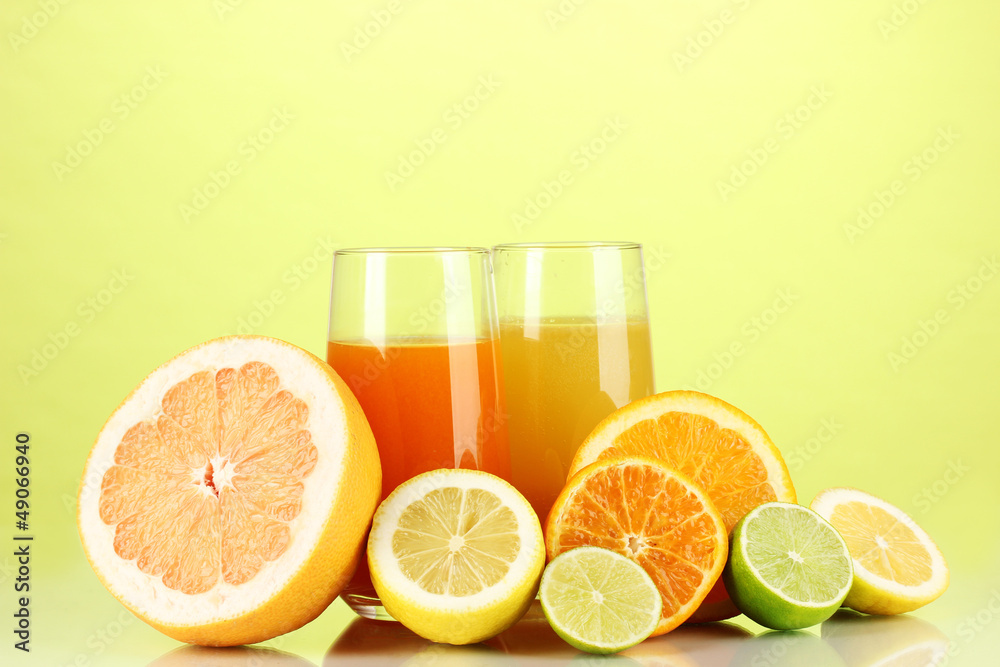 Lots ripe citrus with juices on green background Lots ripe citrus with juices on green background