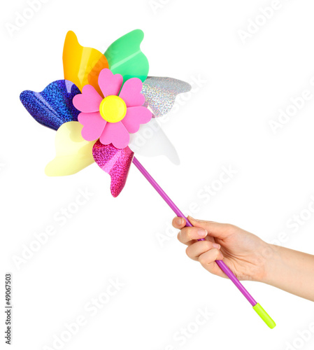 Colored pinwheel in hand isolated on white © Africa Studio