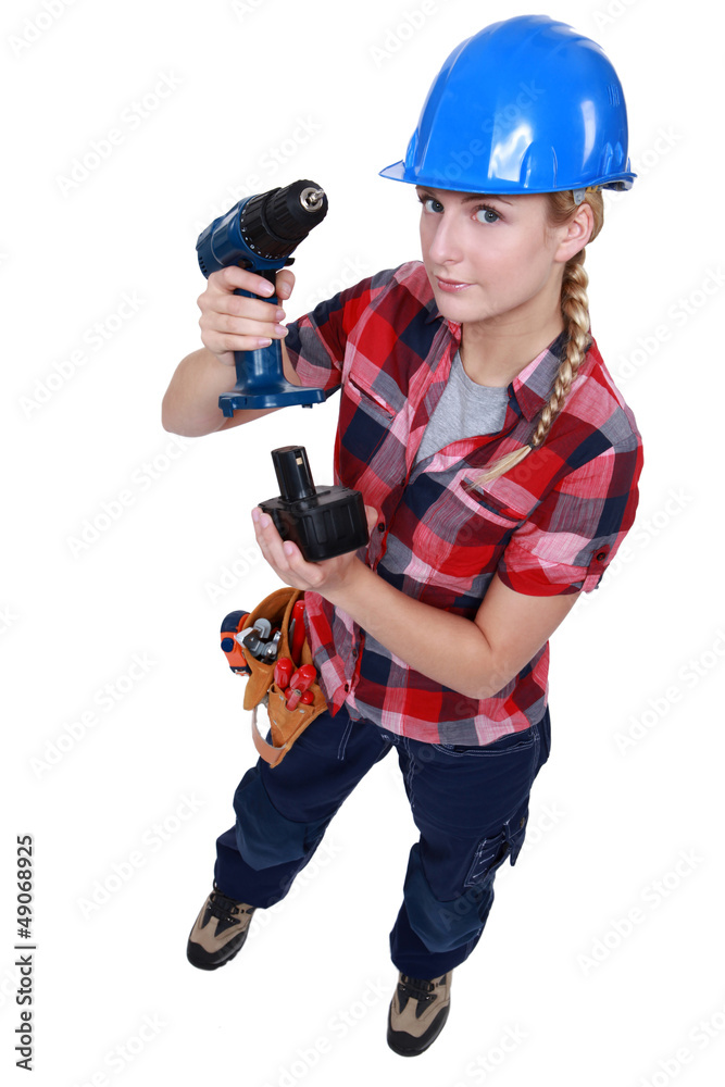 craftswoman putting a charger in a drill craftswoman putting a charger in a drill