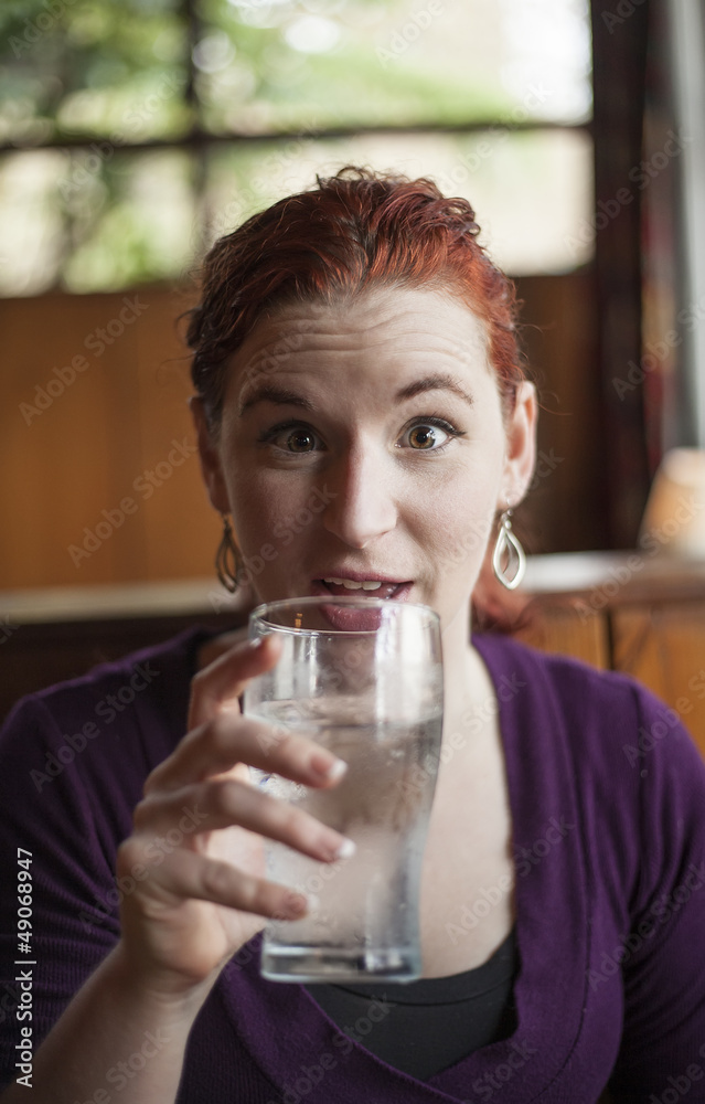 Young Woman with Beautiful Auburn Hair Drinking Water Young Woman with Beautiful Auburn Hair Drinking Water