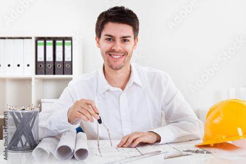 Architect working on blueprints photo