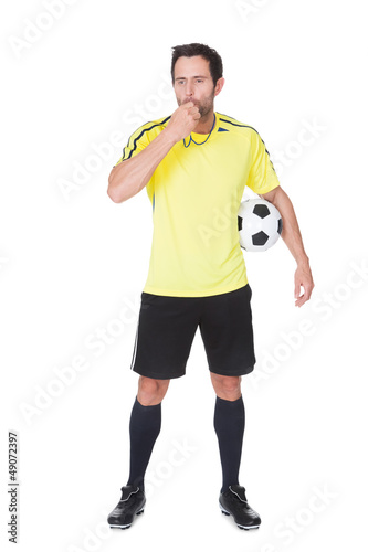 Soccer judge standing with ball