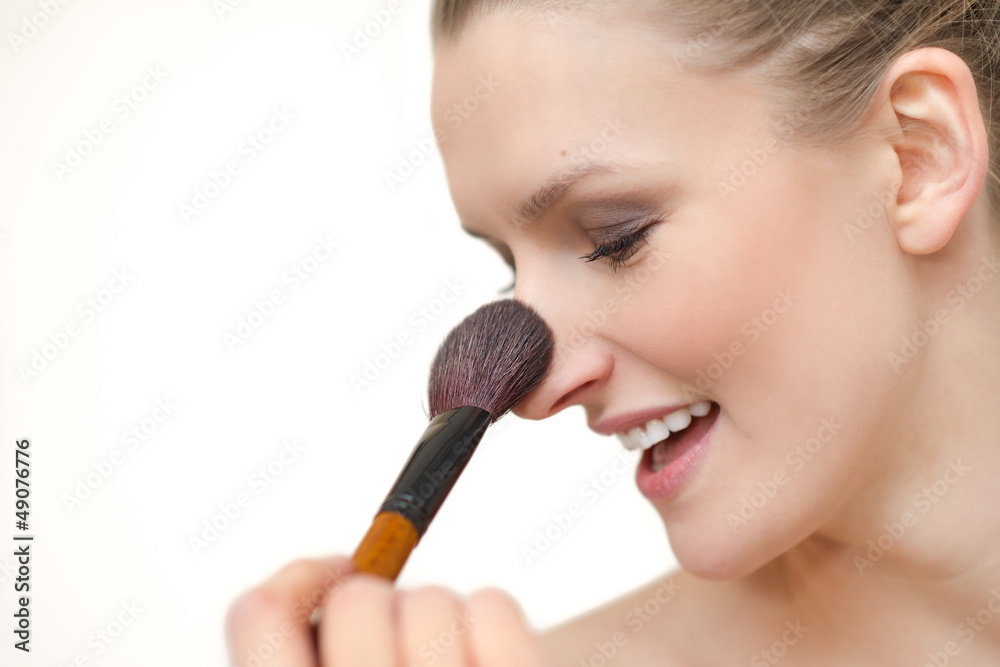 Naklejka premium Closeup portrait of woman face - makup - with brush