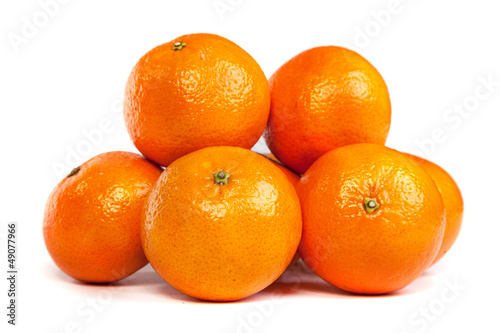 Group of ripe tangerine or mandarin with slices on white
