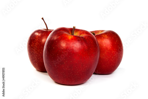 Three shiny red apples isolated on white