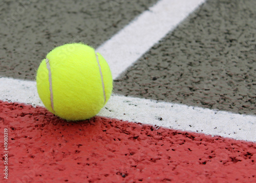 Tennis Ball on a court line © giideon