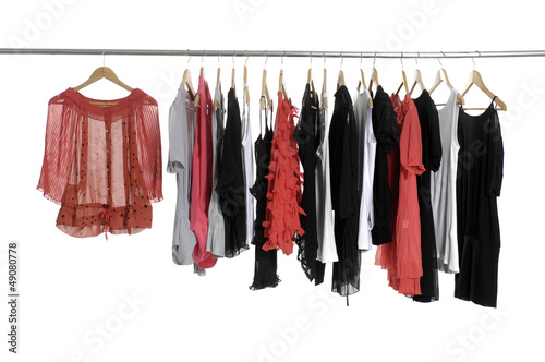 Colorful collection of women's clothes hanging