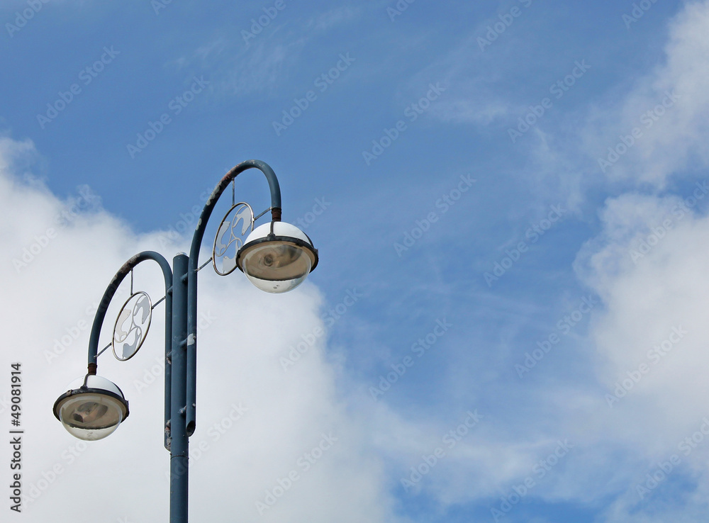 Old fashioned street lamp against the blue sky Old fashioned street lamp against the blue sky