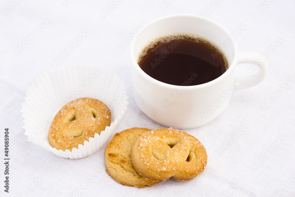 Cup of coffee with cookies on white cloth. Cup of coffee with cookies on white cloth.