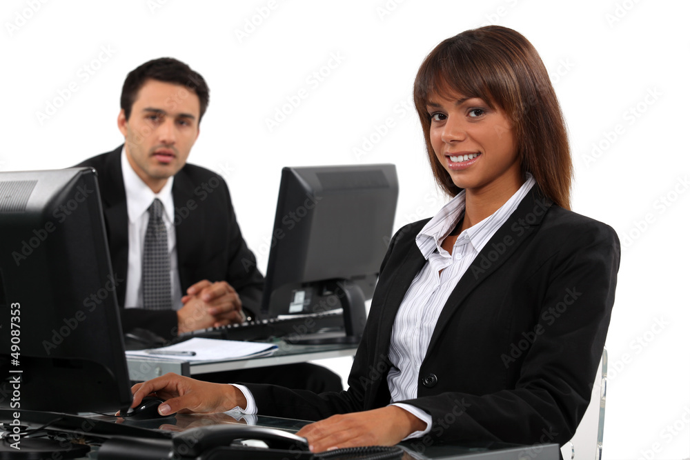 Business professionals working behind their desks Business professionals working behind their desks