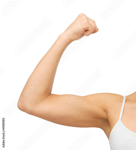 sporty woman flexing her biceps photo