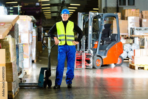 Warehouseman in protective vest using a scanner