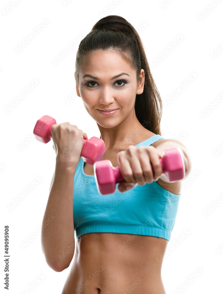 Athletic young woman works out with pink dumbbells Athletic young woman works out with pink dumbbells