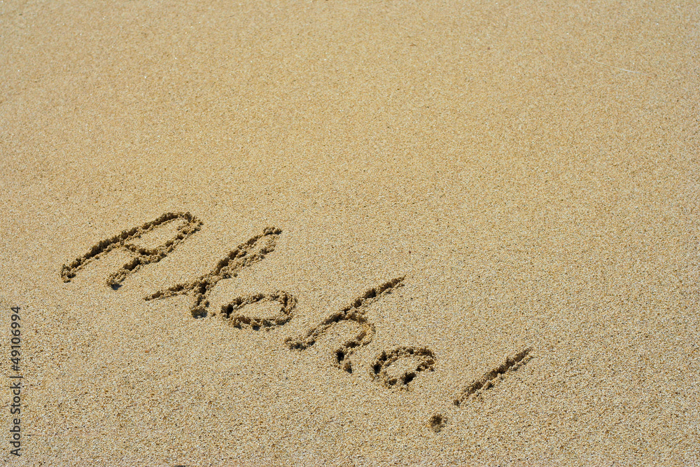 Fototapeta premium Aloha handwritten in sand on a beach