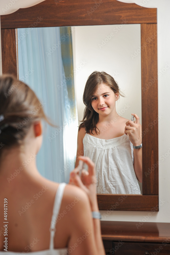 Teen pretty girl happy with their appearance in the mirror Teen pretty girl happy with their appearance in the mirror