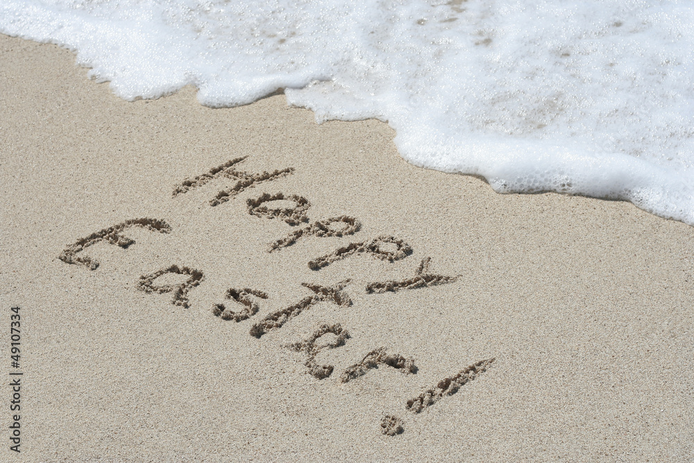 Fototapeta premium Conceptual handwritten text Happy Easter in sand