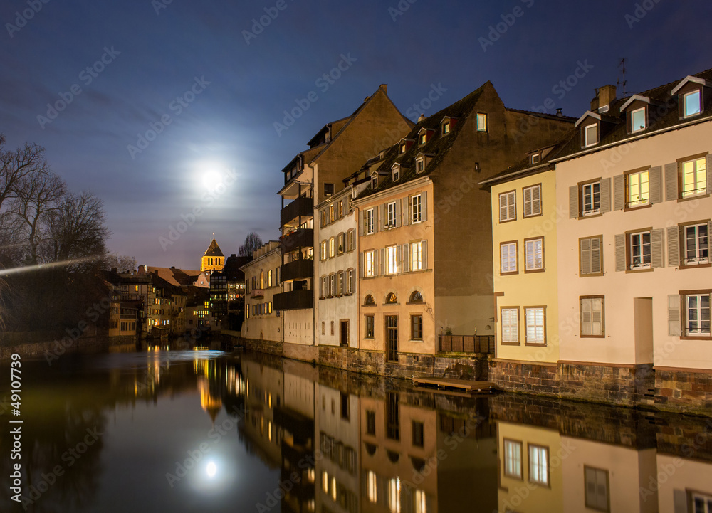 Moon over Ill river in Petite France area, Strasbourg - France