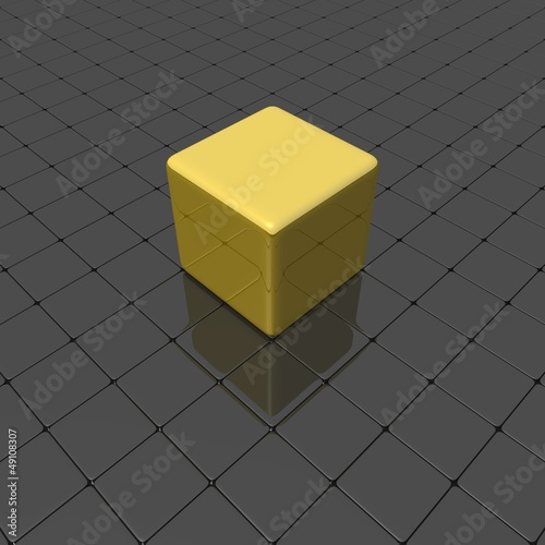 Gold cube on a smooth black surface