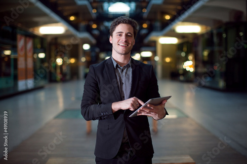 Homme caucasien souriant avec une tablette