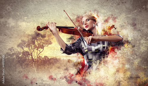 Gorgeous woman playing on violin © Sergey Nivens