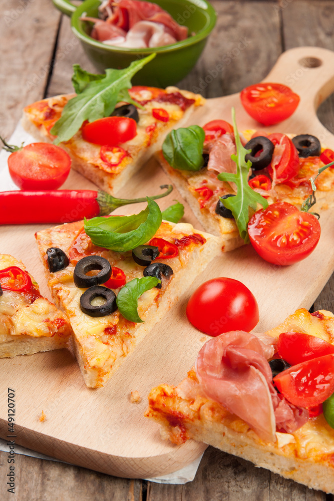 Pizza with ham, pepper and olives on old wooden background Pizza with ham, pepper and olives on old wooden background