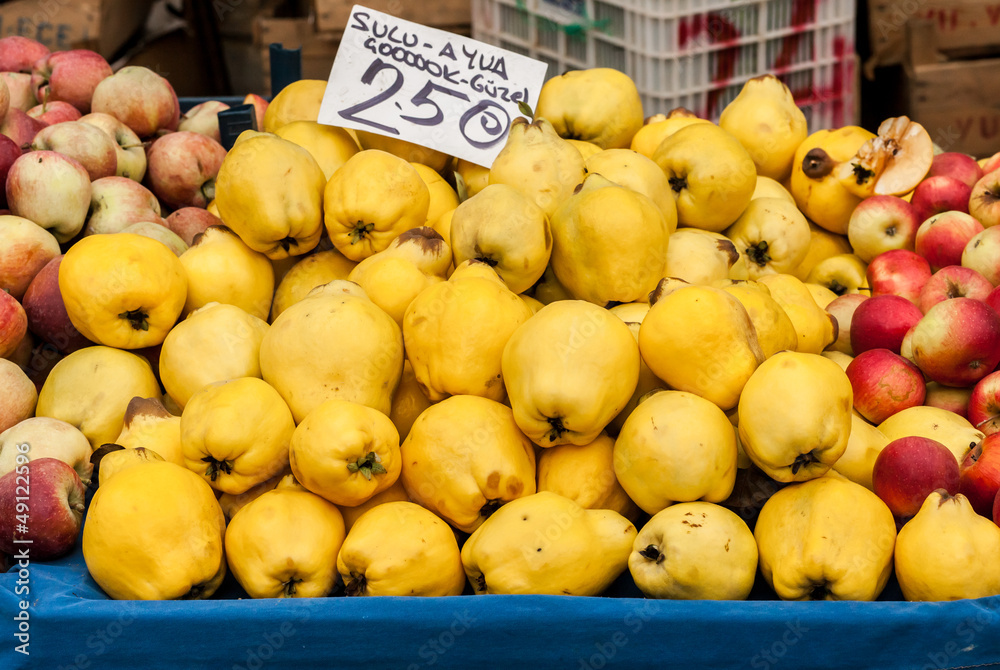 Many quince on stand at open air market in Turkey